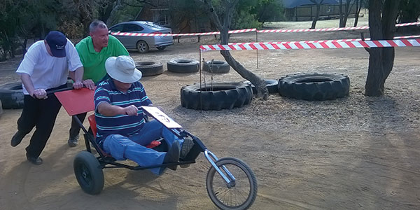 George and Carlos pushing Melt in a go cart.